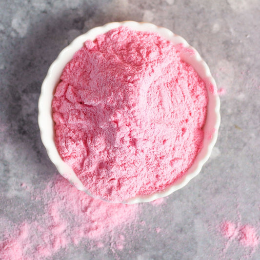 Sakura powder in a white bowl on a gray surface